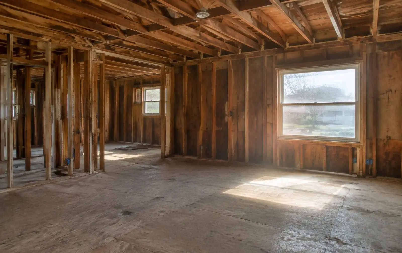 Older home interior stripped to the studs during evaluation